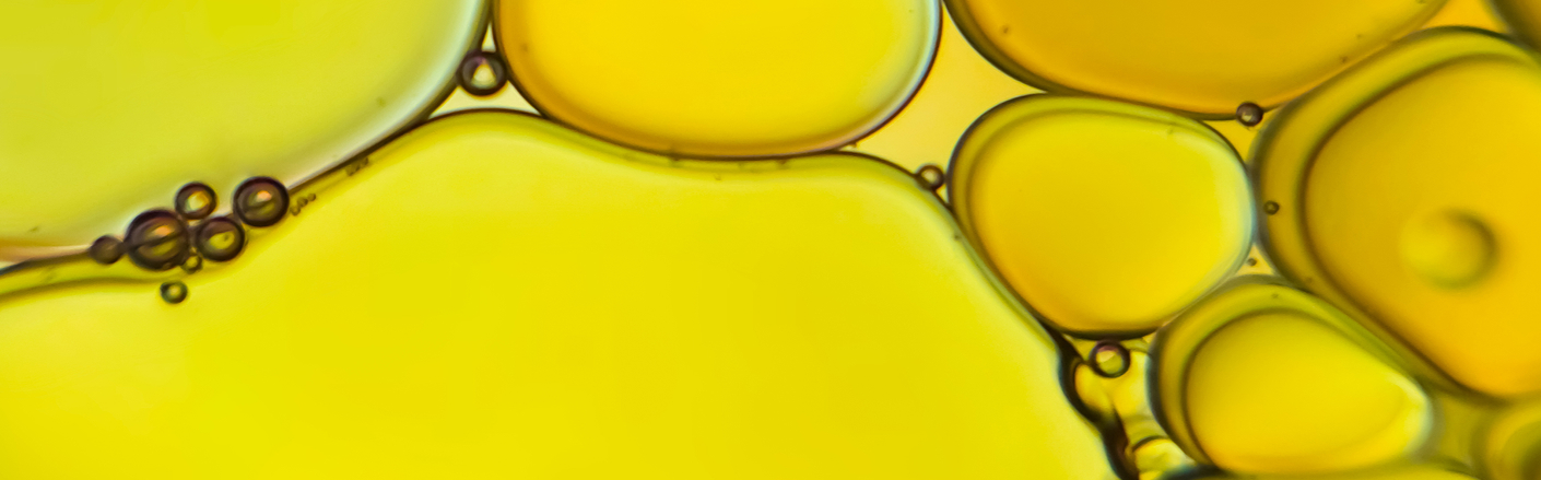 Close-up of golden amber liquid droplets suggesting cannabis oil